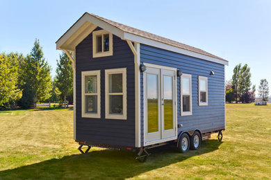 Photo of a small beach style one-storey blue exterior in Vancouver with wood siding and a gable roof.