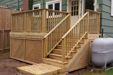 This is an example of a small modern backyard deck in Other with no cover.