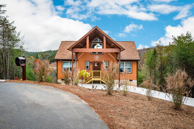 Rustic brown concrete fiberboard and clapboard exterior home idea in Charlotte with a shingle roof and a brown roof