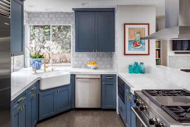 Mid-sized transitional u-shaped dark wood floor kitchen photo in San Diego with a farmhouse sink, recessed-panel cabinets, blue cabinets, granite countertops, gray backsplash, ceramic backsplash, stainless steel appliances and no island