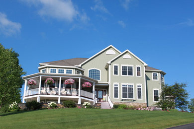 Inspiration for a large craftsman beige three-story wood exterior home remodel in Boston with a shingle roof