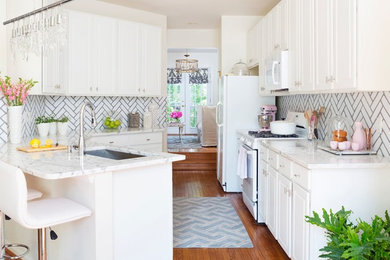 Transitional kitchen in DC Metro with an undermount sink, raised-panel cabinets, white cabinets, white splashback, subway tile splashback, white appliances, medium hardwood floors and a peninsula.