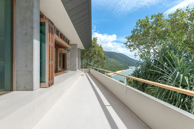 This is an example of an expansive contemporary balcony in Cairns with no cover.