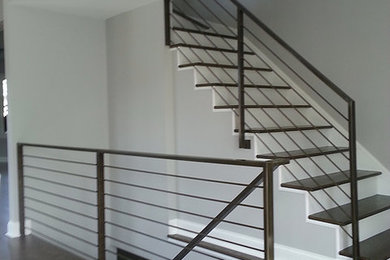 Contemporary wood staircase in Chicago with wood risers.