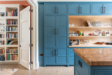 Example of a large classic painted wood floor and multicolored floor kitchen design in London with a drop-in sink, shaker cabinets, blue cabinets, wood countertops, multicolored backsplash, ceramic backsplash and multicolored countertops