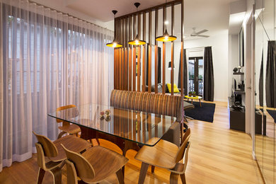 Photo of a small contemporary separate dining room in Brisbane with white walls and light hardwood floors.