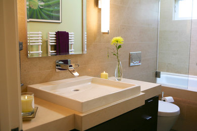 Minimalist beige tile and porcelain tile bathroom photo in San Francisco with a console sink, a wall-mount toilet, flat-panel cabinets, dark wood cabinets and quartz countertops