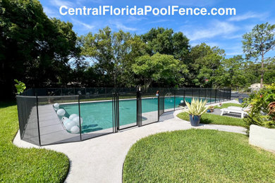 Pool - large modern backyard concrete and rectangular natural pool idea in Orlando