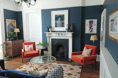 Inspiration for a large victorian formal enclosed living room in Other with dark hardwood flooring, a ribbon fireplace, a wooden fireplace surround, no tv, brown floors and blue walls.