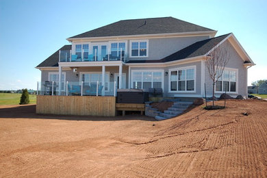 Inspiration for a mid-sized craftsman gray two-story wood house exterior remodel in Other with a hip roof and a shingle roof