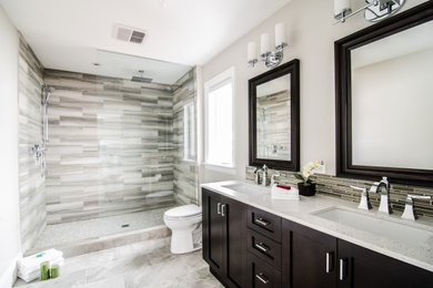 Mid-sized transitional master porcelain tile, multicolored floor and double-sink bathroom photo in Toronto with raised-panel cabinets, dark wood cabinets, a two-piece toilet, an undermount sink, quartzite countertops, white countertops and a freestanding vanity