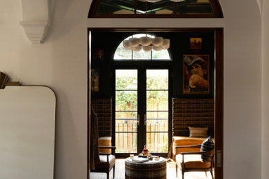 Hallway - mid-sized contemporary medium tone wood floor and brown floor hallway idea in Houston with beige walls