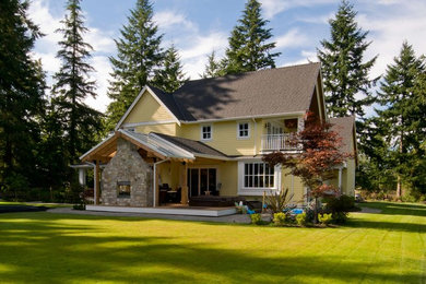 Inspiration for a mid-sized timeless yellow wood exterior home remodel in Vancouver