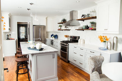 Inspiration for a mid-sized transitional l-shaped medium tone wood floor and beige floor eat-in kitchen remodel in Toronto with a farmhouse sink, shaker cabinets, gray cabinets, quartzite countertops, white backsplash, porcelain backsplash, stainless steel appliances and an island