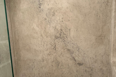 Example of a mid-sized classic master concrete floor and beige floor bathroom design in Chicago with glass-front cabinets and multicolored walls