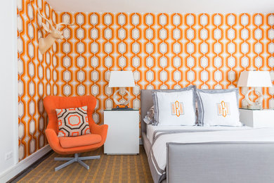 Example of a transitional bedroom design in Houston with orange walls
