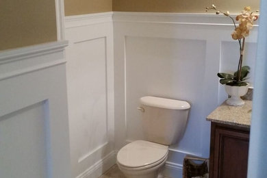 Mid-sized minimalist bathroom photo in New York with dark wood cabinets, yellow walls and recessed-panel cabinets