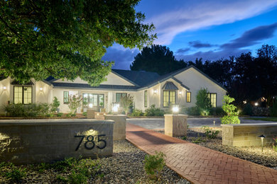 This is an example of a farmhouse front yard concrete paver landscaping in Other.