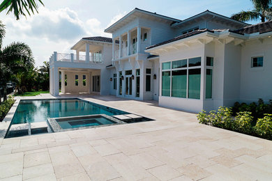 Mid-sized transitional backyard stone patio photo in Miami with a gazebo