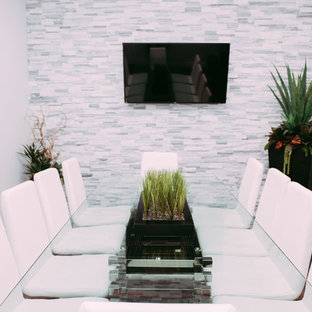 Inspiration for a large modern home office and library in Edmonton with grey walls, ceramic flooring and a hanging fireplace.