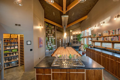 Trendy concrete floor open concept kitchen photo in Seattle with flat-panel cabinets, medium tone wood cabinets and an island