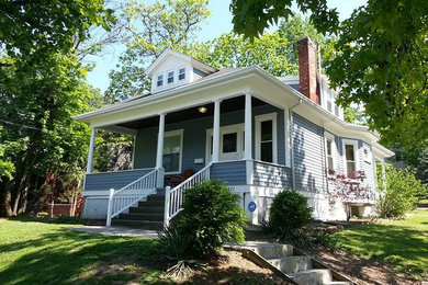 Inspiration for a mid-sized craftsman blue two-story wood house exterior remodel in Cincinnati with a clipped gable roof and a shingle roof
