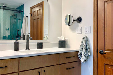 Mid-sized minimalist kids' turquoise tile and ceramic tile porcelain tile, gray floor and single-sink bathroom photo in Other with flat-panel cabinets, light wood cabinets, a two-piece toilet, white walls, an undermount sink, quartz countertops, white countertops, a niche and a built-in vanity