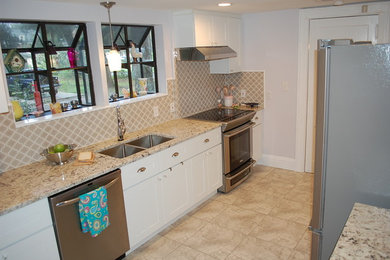 Transitional galley enclosed kitchen photo in Jacksonville with shaker cabinets, white cabinets, granite countertops, gray backsplash and cement tile backsplash