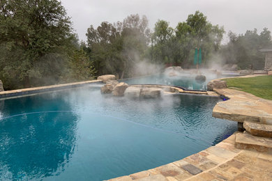 Mountain style pool photo in Orange County