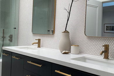 Example of a mid-sized transitional master white tile and mosaic tile porcelain tile, multicolored floor and double-sink bathroom design with flat-panel cabinets, black cabinets, a one-piece toilet, white walls, an undermount sink, quartz countertops, white countertops, a niche and a floating vanity