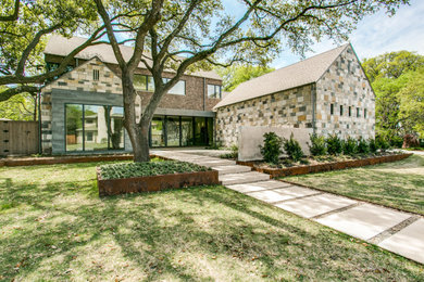 Example of a large trendy multicolored two-story mixed siding exterior home design in Dallas with a shingle roof
