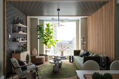 Example of a mid-sized minimalist open concept light wood floor, wallpaper ceiling and wood wall living room design in Boston with black walls, no fireplace and a wall-mounted tv