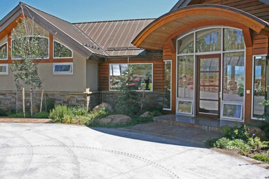 Inspiration for a large contemporary beige one-story mixed siding exterior home remodel in Denver