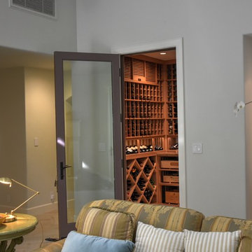Laguna Hills Orange Small County Custom Wine Cellar with Wrought Iron Door