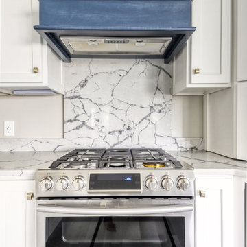 Navy Stained Island, Hood vent and Floating Shelves in White Shaker Kitchen