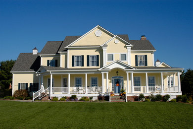 Inspiration for a timeless yellow house exterior remodel in DC Metro