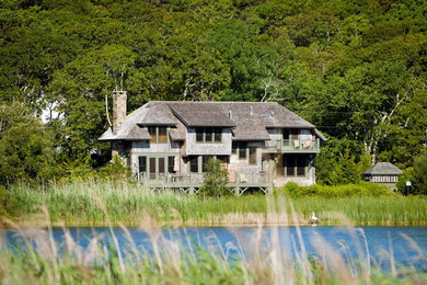 Inspiration for a large coastal beige two-story wood exterior home remodel in Boston with a hip roof