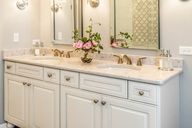 Example of a large transitional master white tile and stone tile porcelain tile and beige floor bathroom design in Chicago with an undermount sink, white cabinets, quartz countertops, a two-piece toilet, gray walls and raised-panel cabinets