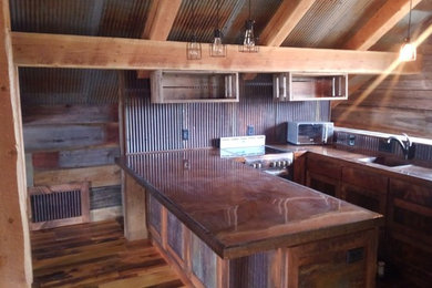 Example of a small mountain style u-shaped medium tone wood floor and brown floor enclosed kitchen design in Other with an undermount sink, medium tone wood cabinets, brown backsplash, a peninsula and brown countertops