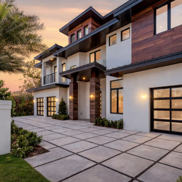 Twilight Elevation: Full-View Impact Garage Doors & Estate Glazing