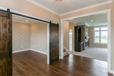Inspiration for a mid-sized timeless medium tone wood floor and brown floor foyer remodel in Cedar Rapids with beige walls