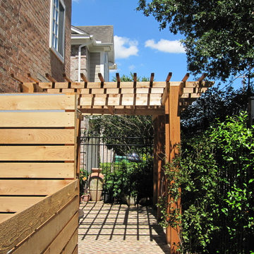 High function in a small side yard! Pergola, raised bed, mirrored wall, fountain