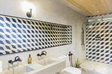 Photo of a contemporary master bathroom with an open shower, gray tile, cement tile, grey walls, an integrated sink, concrete benchtops and grey benchtops.