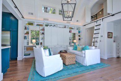 Example of a mid-sized beach style enclosed light wood floor family room design in San Francisco with white walls