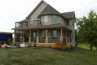 Inspiration for a large contemporary front porch remodel in Toronto with decking