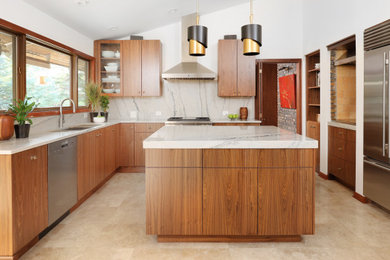 Example of a mid-sized 1960s u-shaped travertine floor, beige floor and vaulted ceiling eat-in kitchen design in Chicago with an undermount sink, flat-panel cabinets, medium tone wood cabinets, quartzite countertops, white backsplash, stone slab backsplash, stainless steel appliances, an island and white countertops