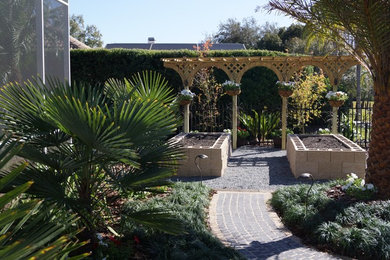 Inspiration for a small transitional side yard partial sun formal garden in Orlando with brick pavers.