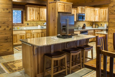 Inspiration for a mid-sized rustic l-shaped slate floor and gray floor eat-in kitchen remodel in Other with medium tone wood cabinets, granite countertops, stainless steel appliances, an island, an undermount sink and shaker cabinets