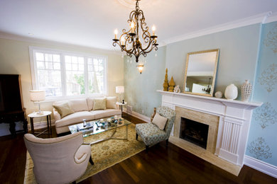 Example of a mid-sized transitional open concept dark wood floor, brown floor and wallpaper living room design in Toronto with blue walls, a standard fireplace and a stone fireplace
