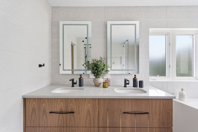Inspiration for a large modern master beige tile and ceramic tile gray floor and double-sink bathroom remodel in Ottawa with flat-panel cabinets, brown cabinets, a one-piece toilet, beige walls, an undermount sink, quartz countertops, gray countertops, a niche and a floating vanity
